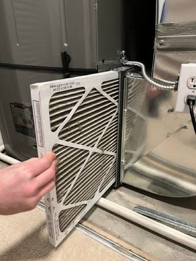 Removing dirty furnace filter.