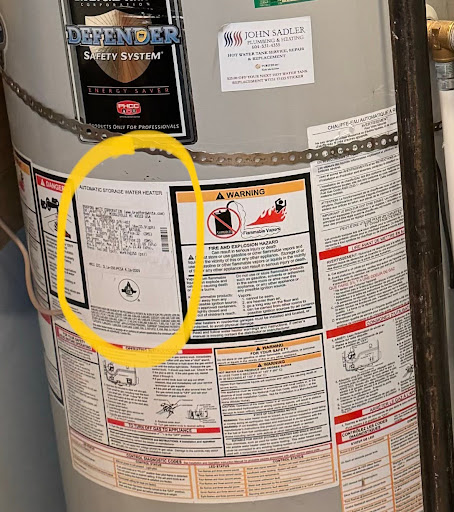 A hot water tank with the serial-number label circled.